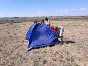 Boys learning how to pitch a tent