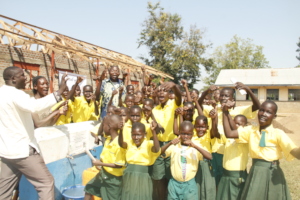Students at Ojinga Primary School water point