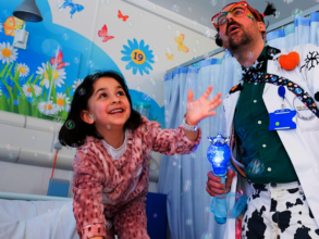 Dr Cowpat and child playing with bubbles