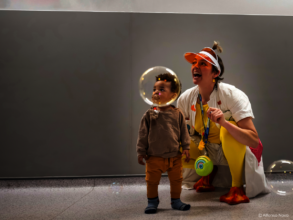 Dr Dilly Dally and child playing with bubbles