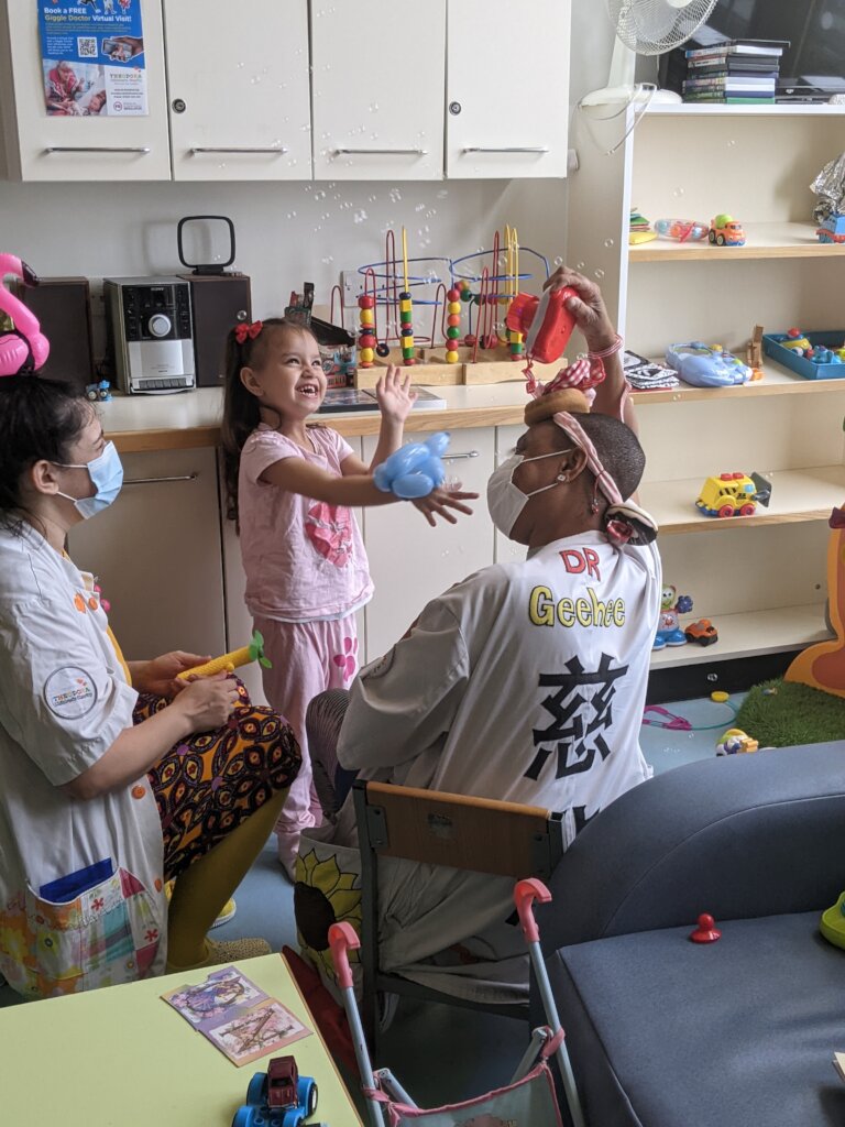Dr Geehee visiting a child at the Royal Alex