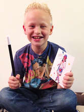Thomas holding his wand and postcard from Dr Faffy