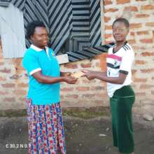 PLANE Staff Handing Over Fees to the girl