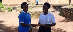 Handing Over fees to Kemigisa Senior Three Student