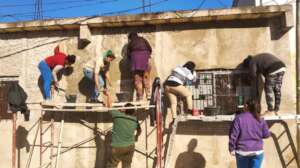 Plastering the wall of the Community Dining Room.