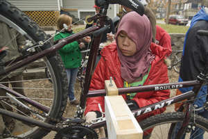 Student repairing bikes for Open Roads