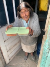 Margarita receives her daily meal from BP staff