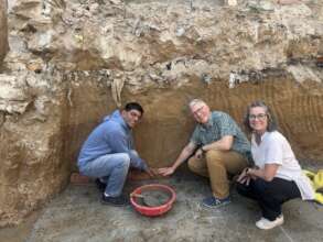 Board members laying a couple foundation stones
