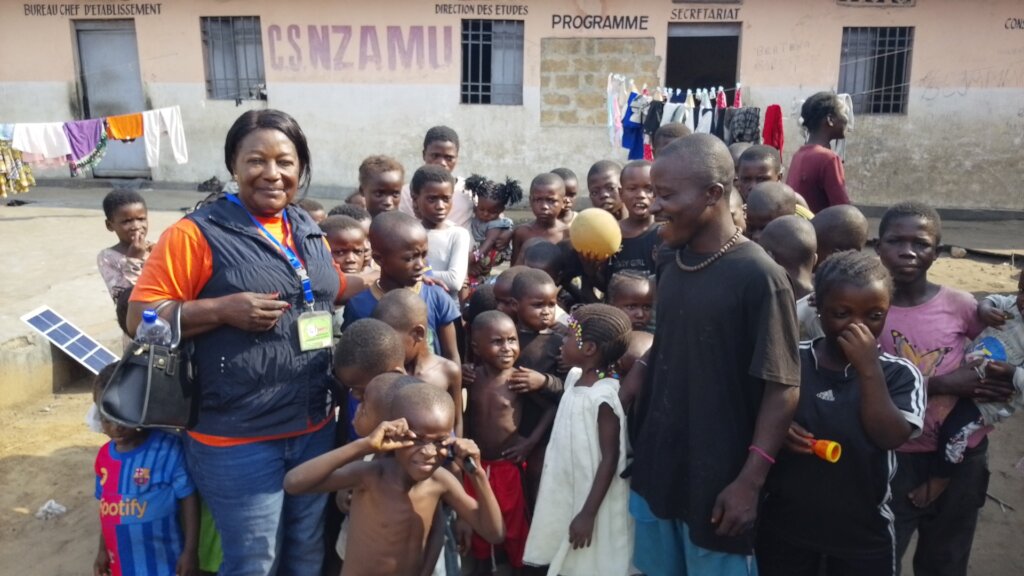 Our Team member posing with children after games