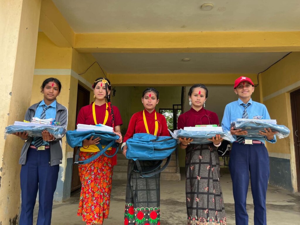Distributing school supplies to our students.