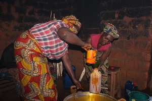 Women heating the Palm oil in order to share