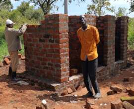 Happy Husband of Jennifer infront of new latrine