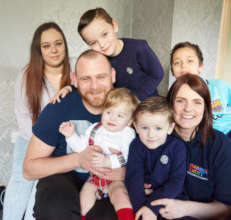 Ellis, now 14 months, with his family and Shelly