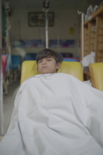A child wrapped in a blanket at KITCC