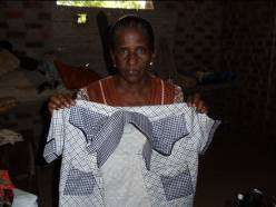 Mrs. Kanmani sews men's shirts to sell at market