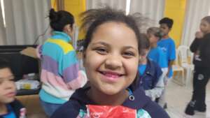 Child with a pink smile during an oral health acti