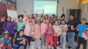 Children proudly display their oral hygiene kits a