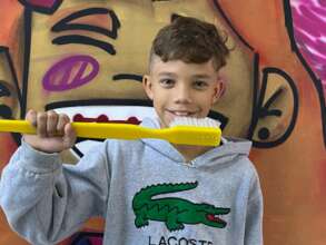 Child with an unusually large toothbrush