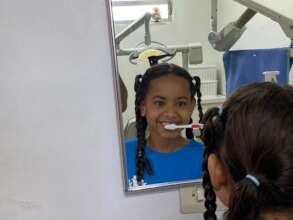 Child learning how to brush their teeth