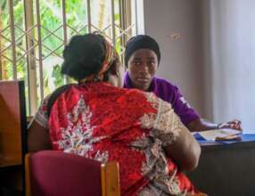 FIDA Legal Officer with client in Kampala