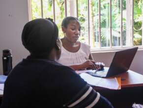 FIDA Legal Officer with client in Kampala
