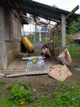 Lonalyn showing the materials to fix the roof