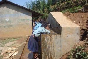 Students drinking water from newly constructed tap