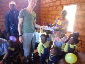 Volunteer handing gifts to the class teacher