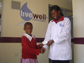 Nurse Helen Okumu and a LiveWell Card Recipient