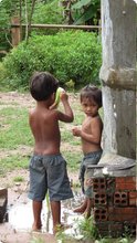 Some kids by Srey Phoom's rainwater storage.