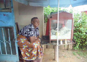 A lady with her pop corn stand