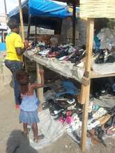 Loan recipient at her used shoes store