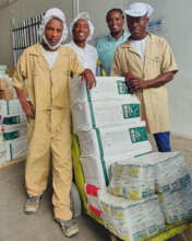 Picking up porridge flour for our feeding project.
