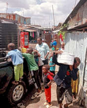 Delivering porridge flour to the beneficiaries.