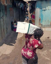Community member assists in project item delivery.