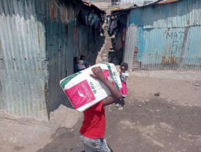 A child offers her support in delivering items.