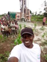 Our Founder-With Children at the drilling site