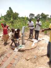 Newly drilled community borehole being constructed
