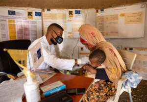 Dr. Mogahed consults with a client and her child.