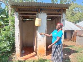 Nyamecheo Member in Front of New Latrine