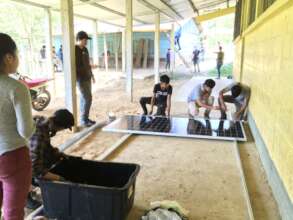 Young students working on the solar installation.