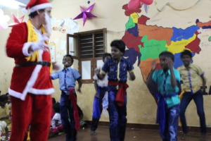Father Christmas dancing with the DSH children