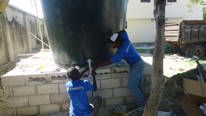 IA plumbers installing a water tank