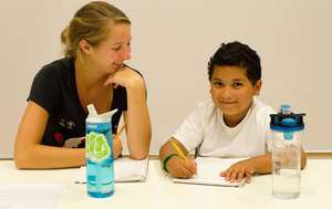 Coach Jules & Jeremy writing in their journals.