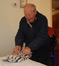 Adolph opening his gift.