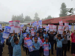 Children carry home the distributed water filter