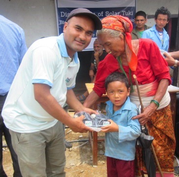 ECCA Program Officer distributing solar lamp