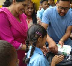 A student receiving the stationery materials