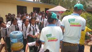 Providing biscuits and juice in Sankhu school
