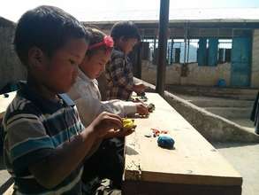 Students in a shed in front of damaged class